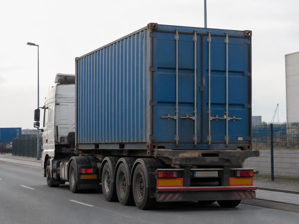 Camion porte-container transportant un container maritime